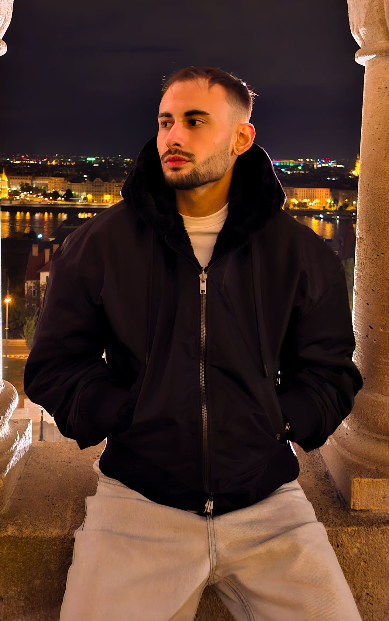 Portrait of Ioannis Papathanasiou overlooking a city at night